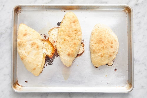 recipe-step-image-Bake the calzones & serve your dish}