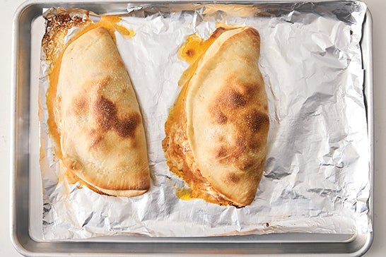 recipe-step-image-Bake the calzones & serve your dish}