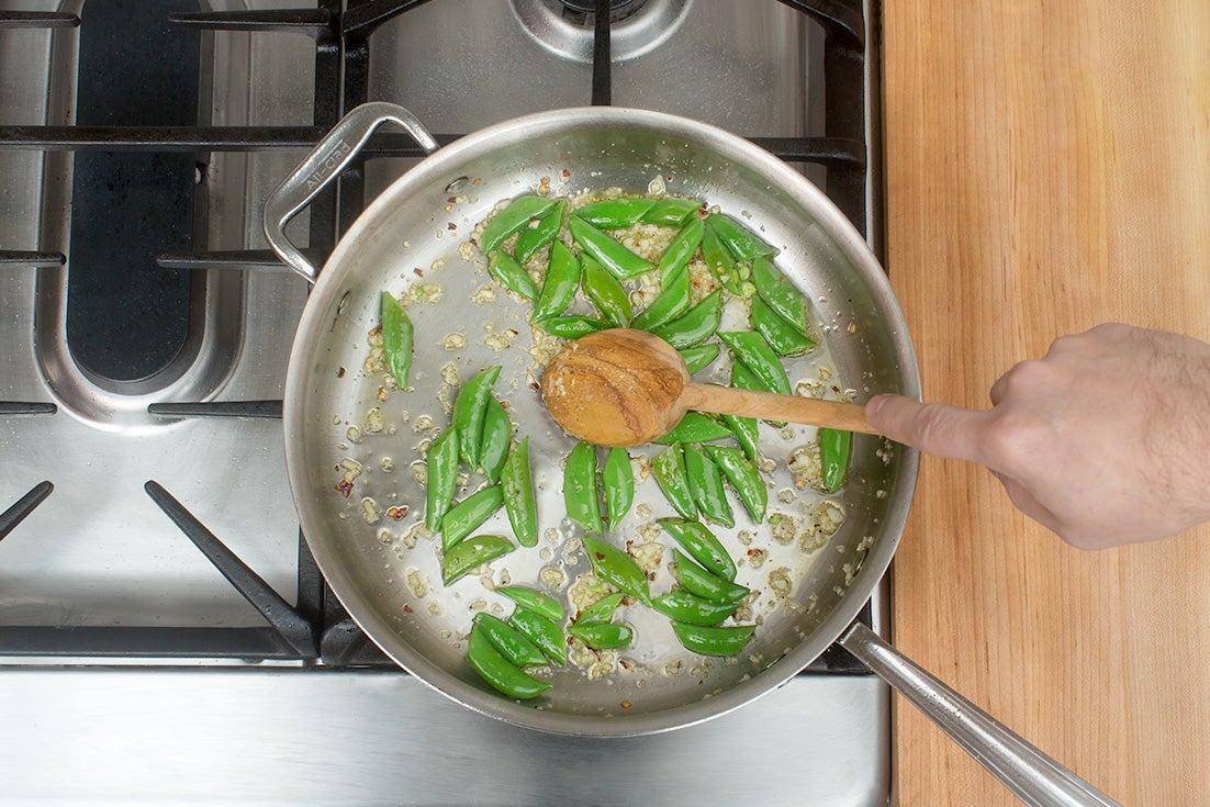 recipe-step-image-Cook the sugar snap peas & aromatics:}
