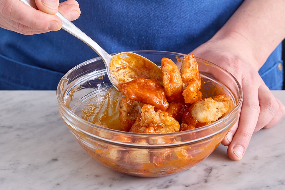 recipe-step-image-Coat, cook, & dress the chicken }