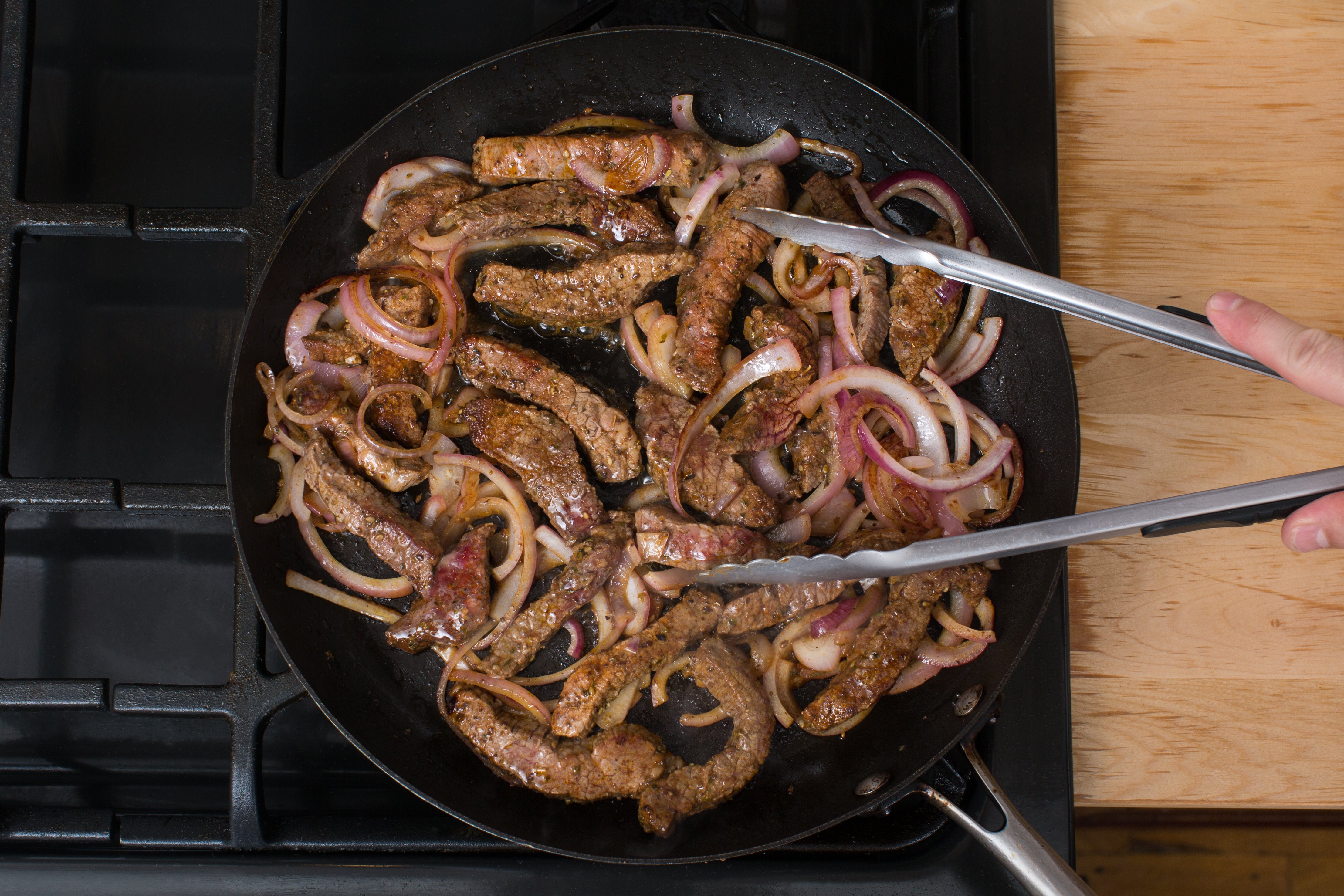recipe-step-image-Cook the steak & onion:}